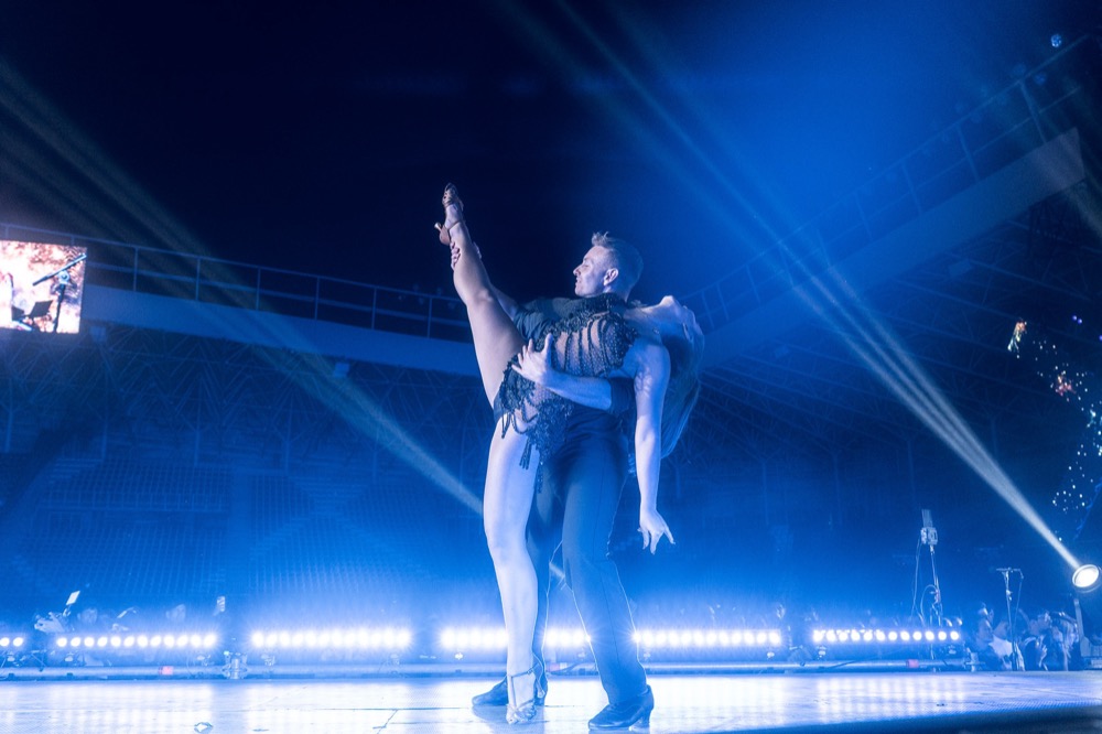 Performer on a blue-lit festival stage